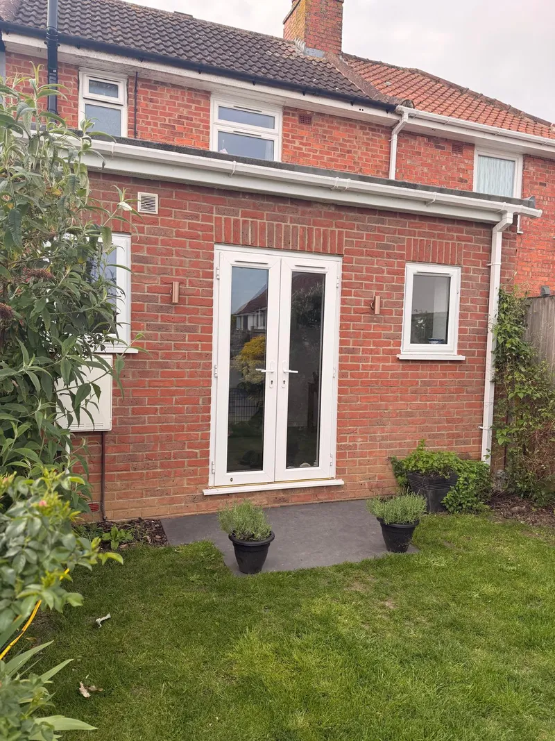 Completed single storey extension in matched red brick with french doors