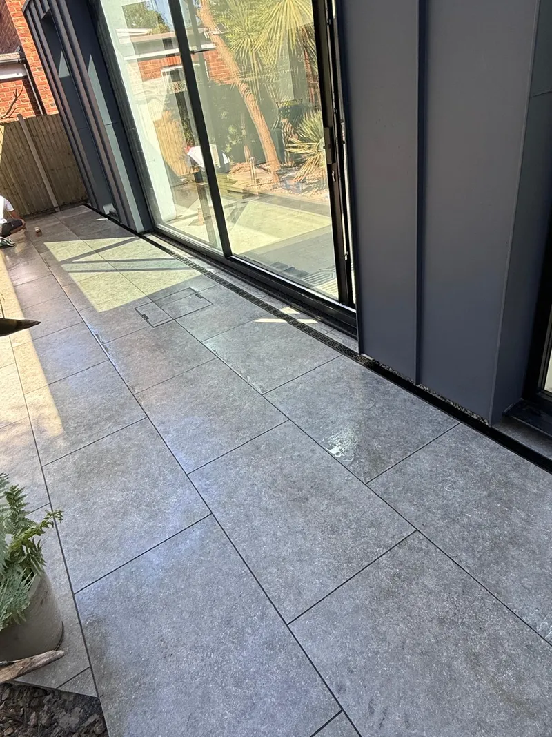 Grey porcelain patio beside a zinc clad extension