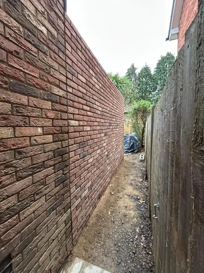 Reclaimed brick boundary wall, hand laid and pointed