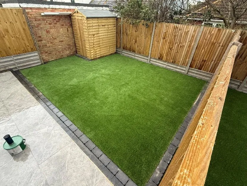Garden reset with porcelain patio and artificial lawn in Hythe