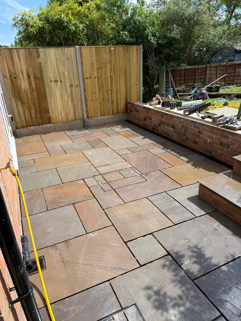Indian sandstone patio with brick raised bed